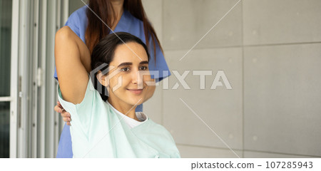 Female Caucasian physiotherapist rehabilitation with Hispanic patient. The doctor doing stretching on patient's pain body for therapy and recovery healthcare. 107285943