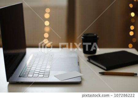 Desk office with laptop, phone, coffee cup, pen on black table. Flat lay top view copy space. Home office. Inspiration moment, workspace or coffee break in the morning. selective focus. Desk office with laptop, phone, coffee cup, pen on black table. Flat lay top view copy space. Home office. Inspiration moment, workspace or coffee break in the morning. selective focus. 107286222