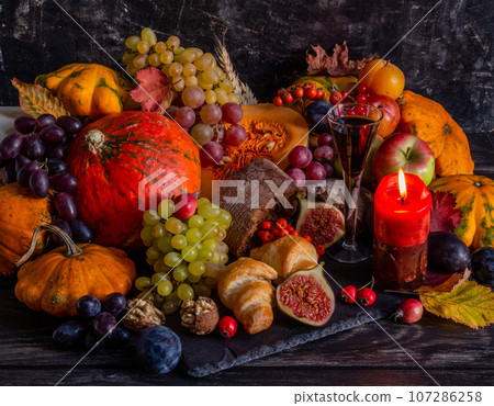 Thanksgiving or Halloween concept, still life with fruits, bountiful harvest Thanksgiving or Halloween concept, still life with fruits, bountiful harvest 107286258
