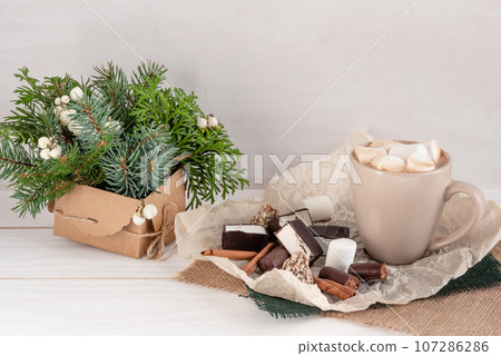 Christmas composition, cocoa with marshmallows on a white background, copy space Christmas composition, cocoa with marshmallows on a white background, copy space 107286286