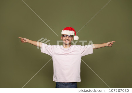 Christmas portrait of happy handsome young man Santa wearing empty t-shirt  107287080