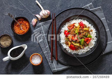 crispy ground beef with stir-fried veggies in bowl 107288489