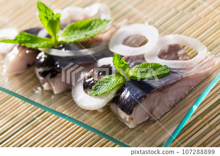 Salted herring with onions is tasty dish 107288899