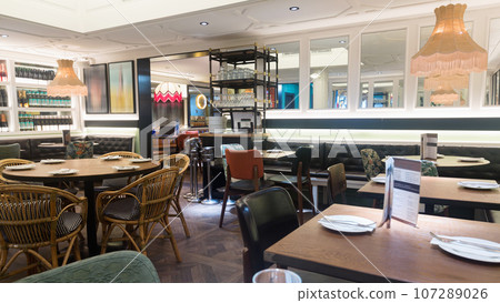 Light interior of cozy hall of modern restaurant in fusion style Light interior of cozy hall of modern restaurant in fusion style 107289026