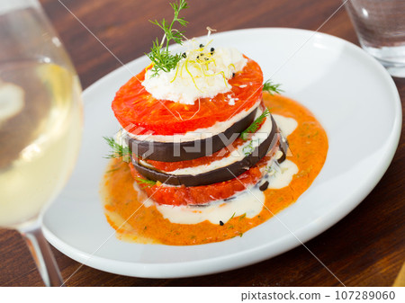 Grilled slices of eggplant and tomatoes Grilled slices of eggplant and tomatoes 107289060