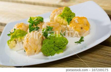 Fish balls with white sauce, broccoli, greens Fish balls with white sauce, broccoli, greens 107289175