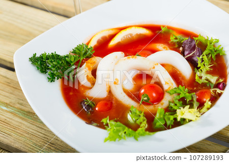 Tomato soup with squid and greens 107289193