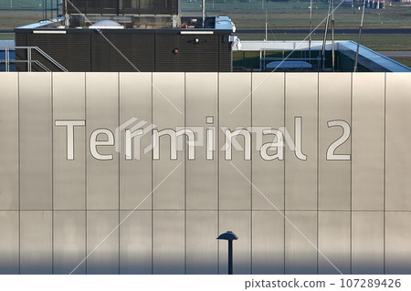 Terminal 2 sign on airport terminal wall 107289426