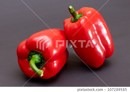 Red Bell Peppers on Black Background 107289585