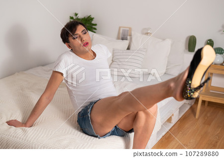 Gay trying on high heels. The guy with makeup. Gay trying on high heels. The guy with makeup. 107289880