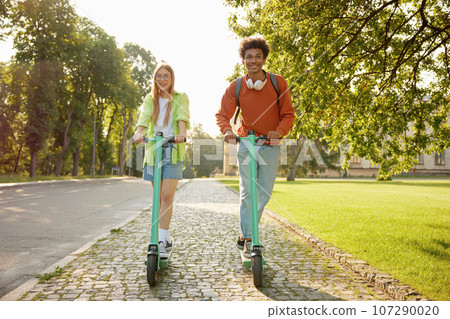 Friends students using electric scooter vehicles 107290020