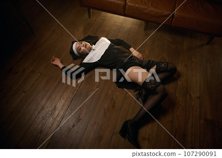 Young sensual nun lying on floor showing her beautiful legs in sexy stockings Young sensual nun lying on floor showing her beautiful legs in sexy stockings 107290091