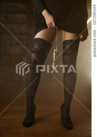 Slender legs of nun in sexy stockings with crucifix on necklace Slender legs of nun in sexy stockings with crucifix on necklace 107290104