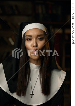 Portrait of naughty sexy nun smoking cigarette Portrait of naughty sexy nun smoking cigarette 107290119