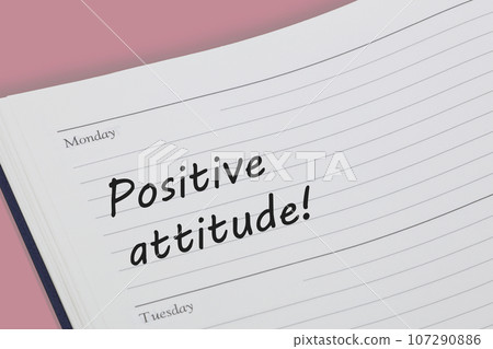 Positive attitude diary reminder open on desk Positive attitude diary reminder open on desk 107290886