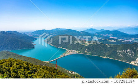Lugano Lake, Italian: Lago di Lugano. Lookout from Balcony of Italy on Mount Sighignola. Italy and Switzerland Lugano Lake, Italian: Lago di Lugano. Lookout from Balcony of Italy on Mount Sighignola. Italy and Switzerland 107291184