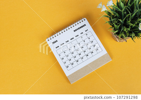 November 2024 desk calendar on yellow background. Directly above. Flat lay. November 2024 desk calendar on yellow background. Directly above. Flat lay. 107291298