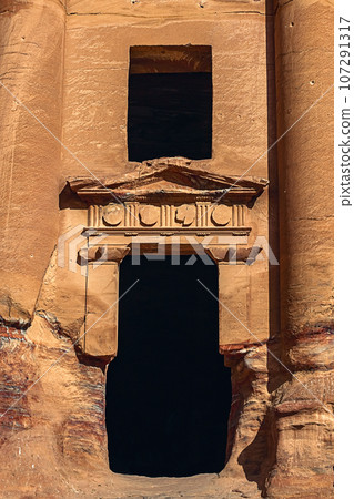 View of the temple and building carved into the sandstone rock. Petra, Jordan. 107291317