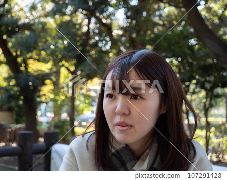 A Beautiful young Japanese woman looking shocked in winter clothes 107291428