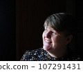 A middle aged lady looking off camera 107291431