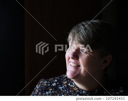 A middle aged lady looking off camera 107291431