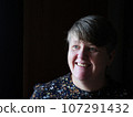A middle aged lady looking off camera 107291432