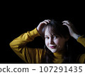 A beautiful young woman posing for portraits 107291435