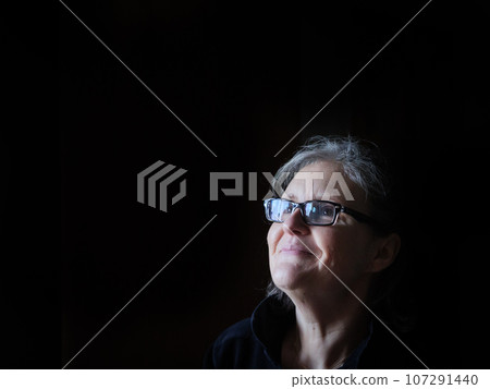A beautiful middle aged lady posing for the camera A beautiful middle aged lady posing for the camera 107291440