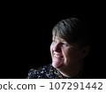 A middle aged lady looking off camera 107291442