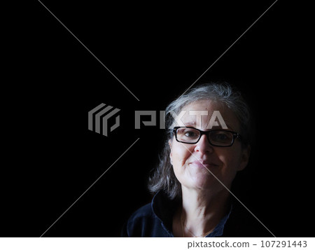 A beautiful middle aged lady posing for the camera A beautiful middle aged lady posing for the camera 107291443