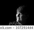 A middle aged lady looking off camera 107291444