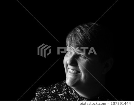 A middle aged lady looking off camera A middle aged lady looking off camera 107291444