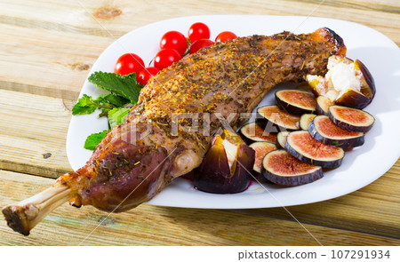 Baked lamb shoulder with figs, tomatoes, feta Baked lamb shoulder with figs, tomatoes, feta 107291934