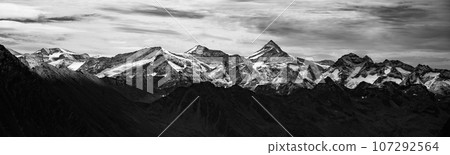 Majestic alpine panorama with mountain of Grossvenediger. The highest peak of Austria. Hohe Tauern mountain range. Black and white photography. Majestic alpine panorama with mountain of Grossvenediger. The highest peak of Austria. Hohe Tauern mountain range. Black and white photography. 107292564