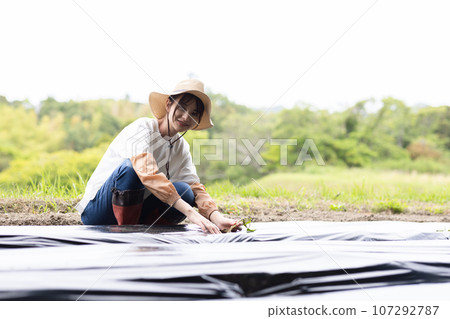 Young woman working in the field Young woman working in the field 107292787
