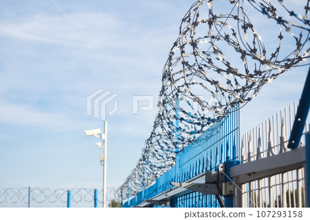 Fence with barbed wire. fencing area around perimeter. Exclusion Zone. Barrier for migrants 107293158