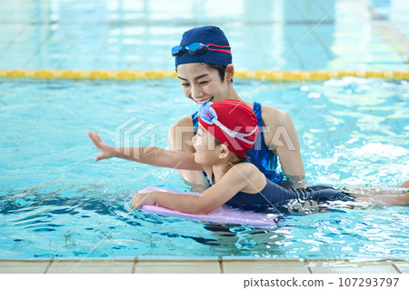 Children and coach practicing swimming 107293797