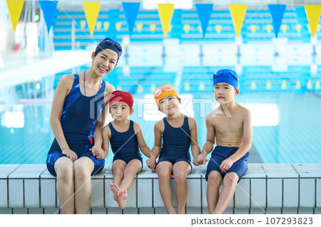 Swimming school kids and coach 107293823