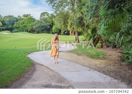 happy pregnant woman walking in the park 107294342