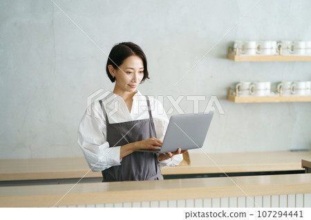Cafe clerk with laptop Cafe clerk with laptop 107294441