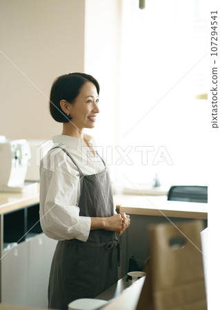 Image of a woman working in a cafe Image of a woman working in a cafe 107294541