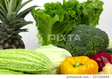Vegetarian and vegan healthy lifestyle concept. Raw vegetables and fruits with empty plate over rustic background 107294944