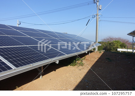 A solar power plant where the ground has subsided and the pedestal has become distorted 107295757
