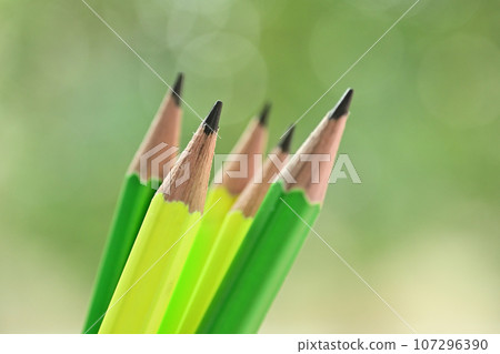 green and yellow sharp pencil on blur nature background with bokeh 107296390
