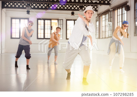 Group of young artists performing street dance Group of young artists performing street dance 107298285