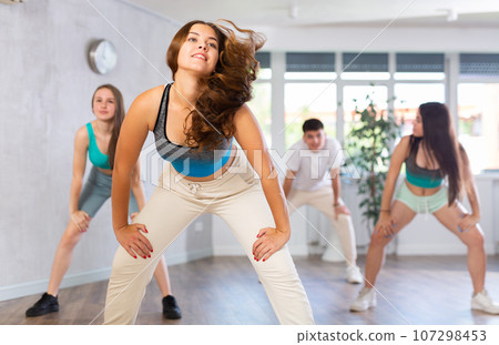 Young girl krumper dancing with group of teenagers in studio Young girl krumper dancing with group of teenagers in studio 107298453