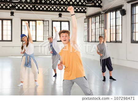 Team of young dancers training moves 107298471