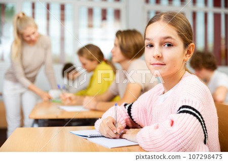 Portrait of schoolgirl at lesson in school Portrait of schoolgirl at lesson in school 107298475