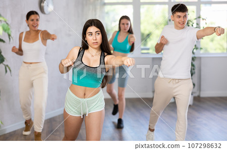 Group of young girls and guy engage self-defence exersice Group of young girls and guy engage self-defence exersice 107298632