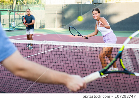 Focused young woman playing friendly tennis match. Concept of concentration in competition 107298747
